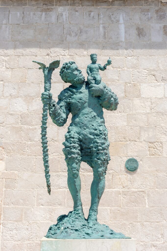 Monument of Saint Christopher with the small Jesus Christ on the shoulder. Rab town, Croatia